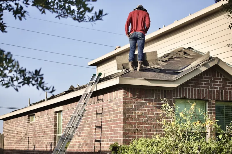 Professional roofer working on a residential roof in Pasadena Hills
